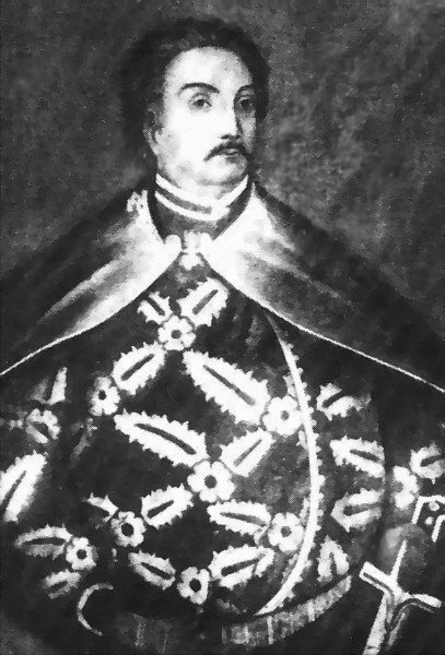 Schwarzes und weißes Foto von Papst Johannes Paul II. in Priestergewändern, der eine schwarze Robe mit weißem Kragen und Manschetten trägt und die Hände verschränkt.