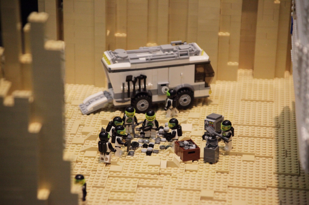 Ein Tisch, der mit verschiedenen Lego-Spielzeugen bedeckt ist, darunter ein Stift, Papier und andere kleine Gegenstände.